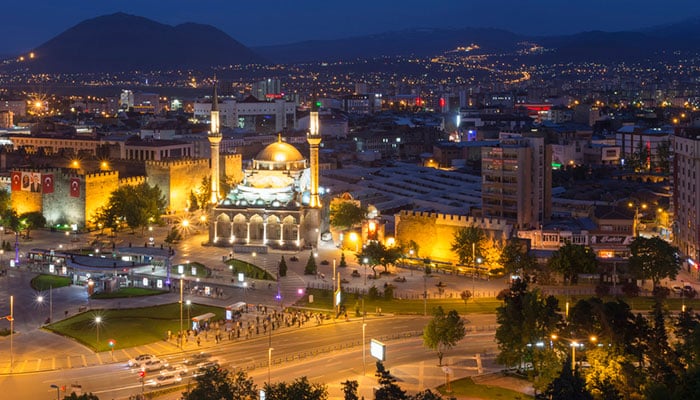 Kayseri city in the night with a lot of lights and mountain background.