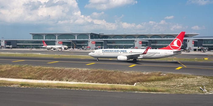 Turkish Airlines plane with Istanbul Airport behind