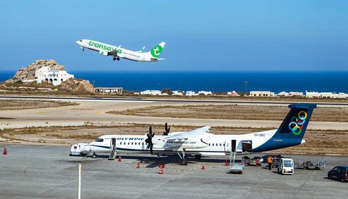 Olympic Airlines plane while Transavia Airline Plane taking off at Santorini Airport (JTR)