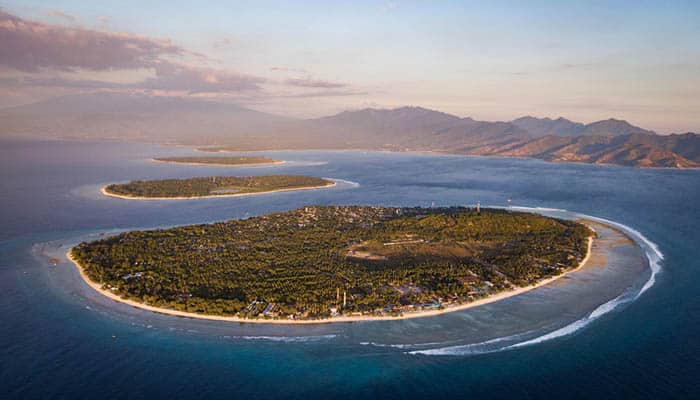 At sunset, an aerial view of the Gili Islands off the coast of Lombok, Indonesia.