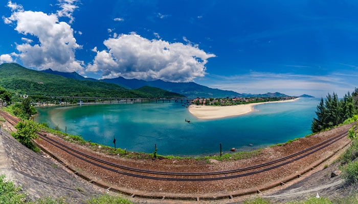 Vung An Cu lagoon near Da Nang city, Vietnam. Beautiful railway line with a lake and beach in the background.