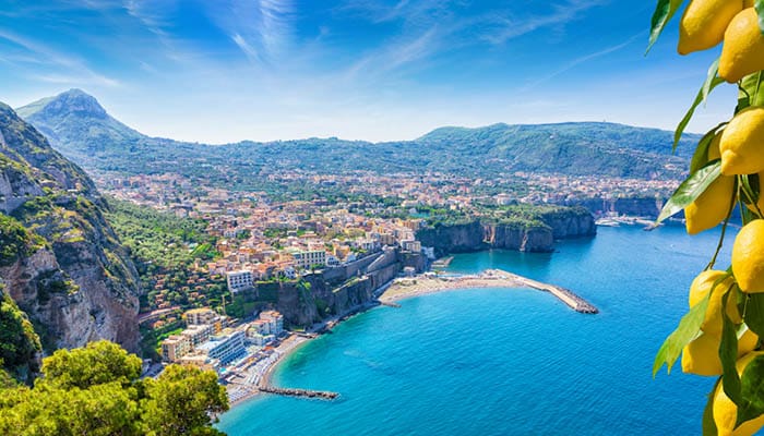 Aerial view of cliff coastline in Sorrento and Gulf of Naples ocean.