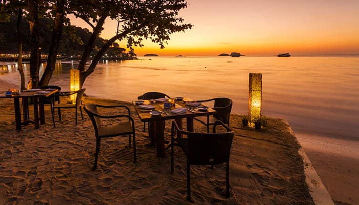 Romantic sunset on the shore of Koh Chang. Restaurant on the beach with sunset background.