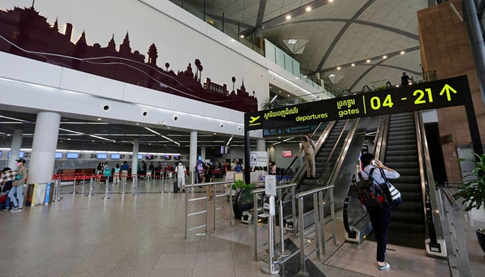 Departure hall of Phnom Penh International Airport with check-in desk in background