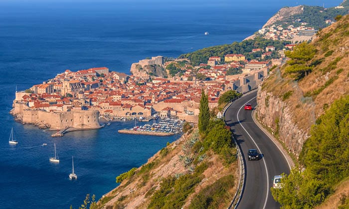 Aerial panoramic view of a road with Dubrovnik and Dalmatian Coast of Adriatic Sea in the background