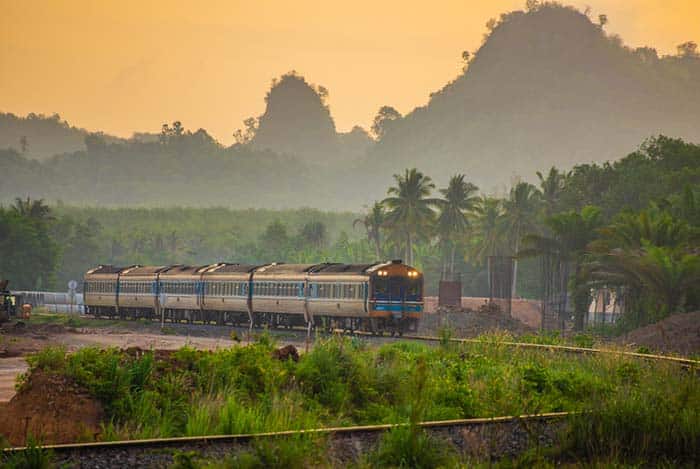 Train No.41 curving in front of a mountain in Chumphon, Thailand.